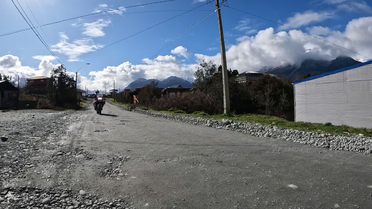 Group of motorcyclists on high-powered motorcycles traveling in the morning on a gravel road