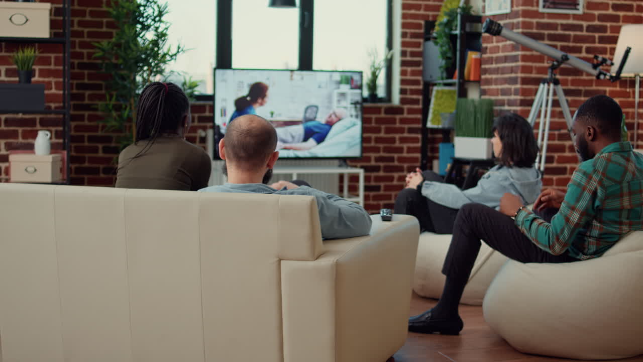 Happy people having fun watching movie on tv channel