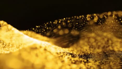 golden particles swirl and flow in captivating patterns, showcasing their dynamic motion.