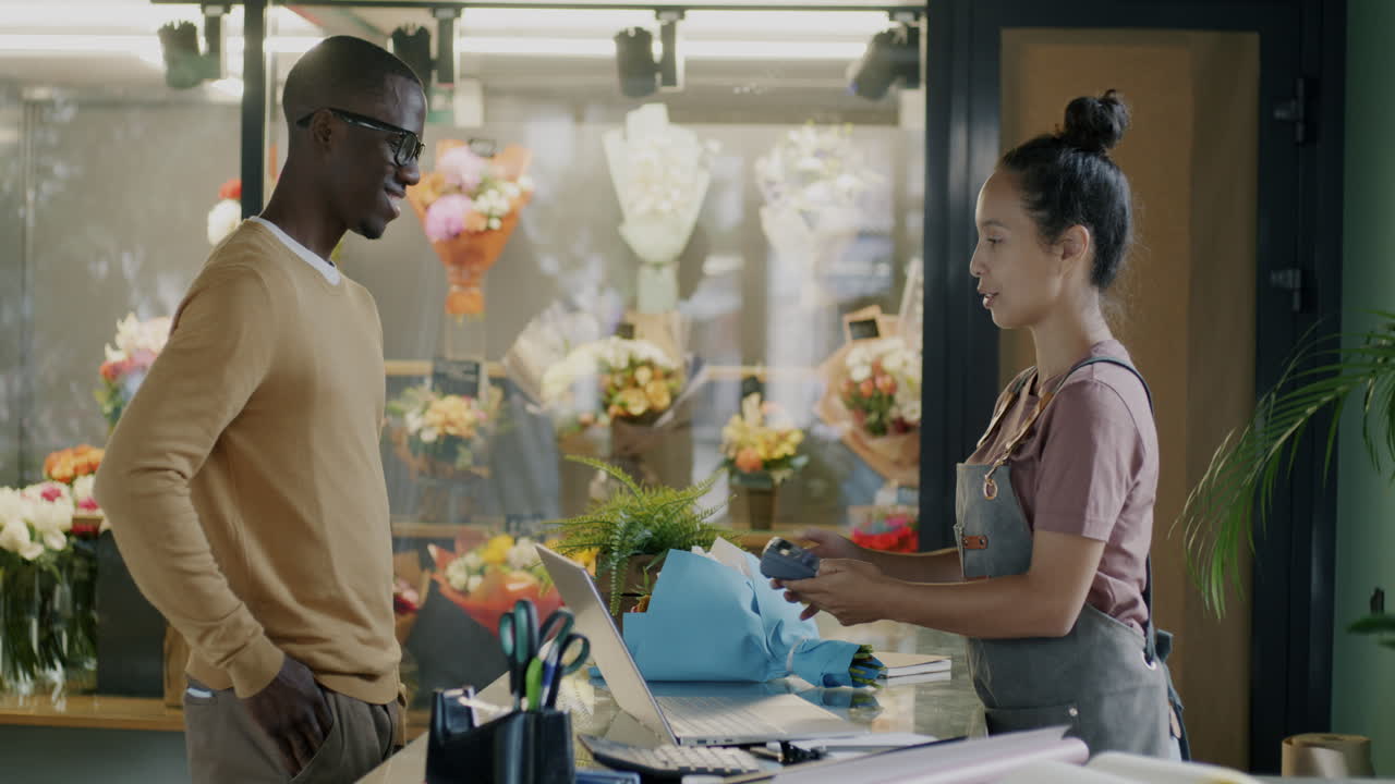 Customer purchasing flowers at a floral shop