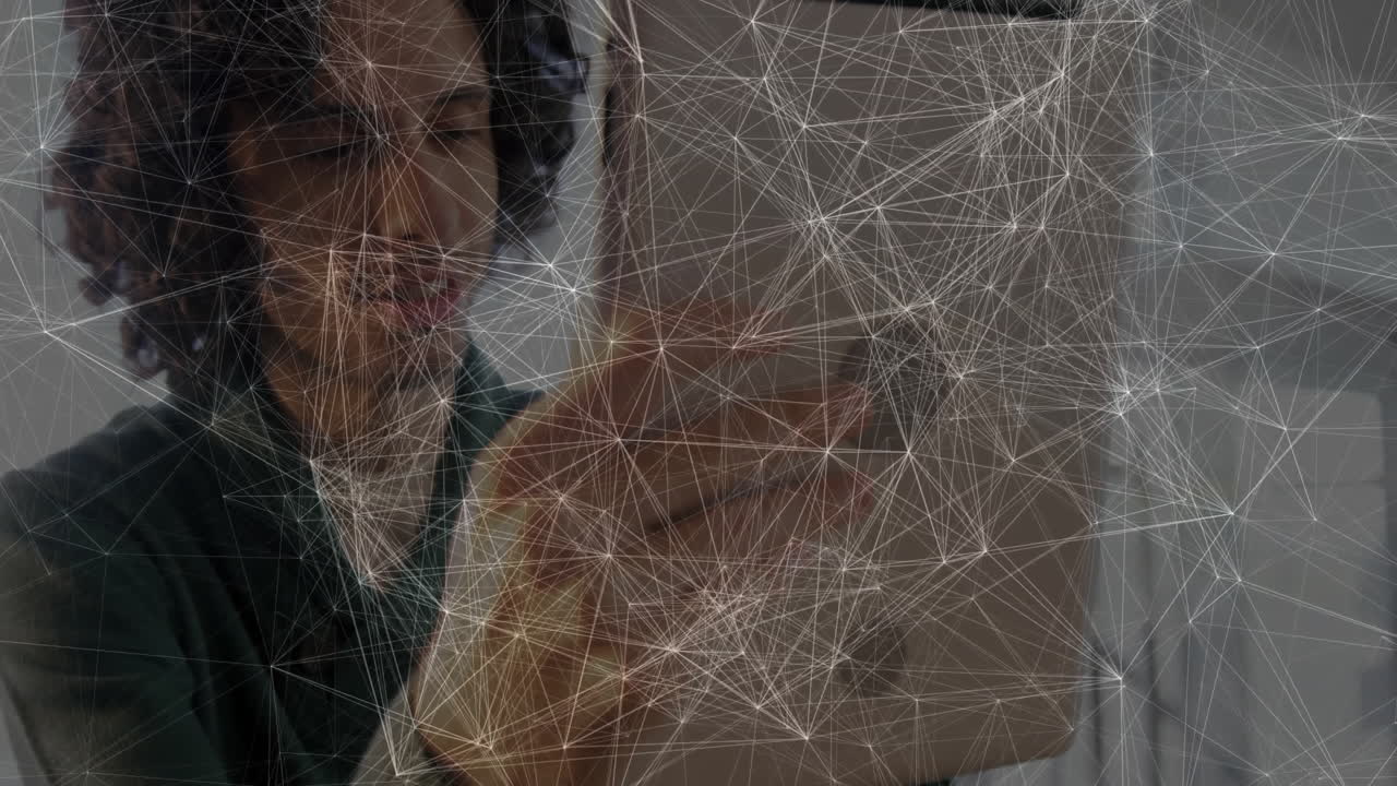 Man holding tablet in office, displaying network mesh visualization powering technology marketing