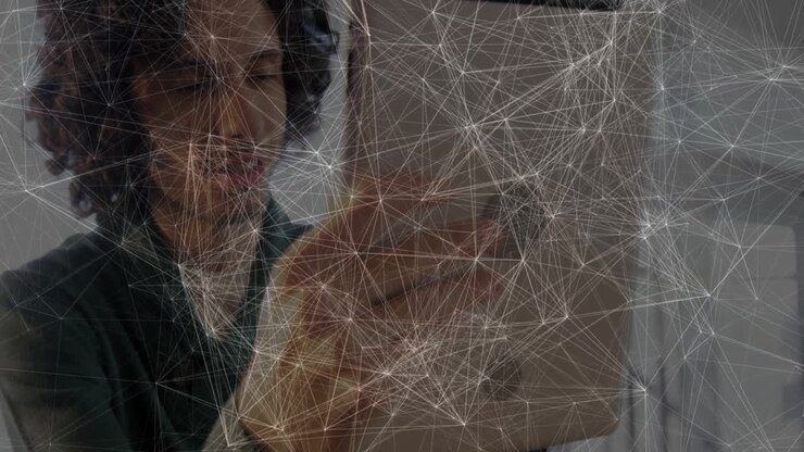 Man holding tablet in office, displaying network mesh visualization powering technology marketing
