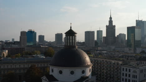 Panorama-curve-shot-of-Holy-Trinity-Church-and-high-rise-buildings-in-background.-Parallax-effect.-Warsaw,-Poland
