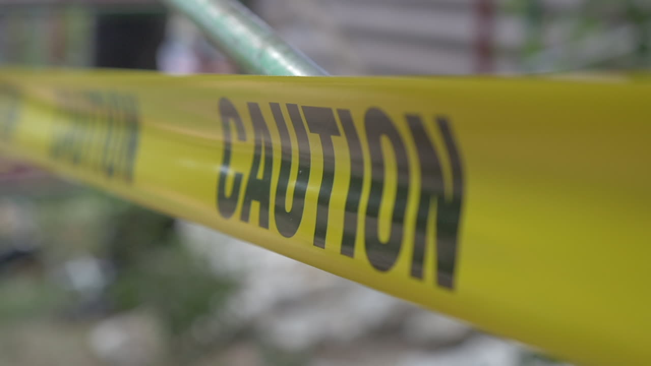 Caution Tape Blowing in the Wind in front of Scafolding, Close Up Slow Motion