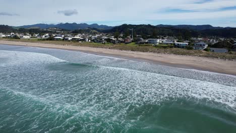 Schäumende-Meereswellen-Brechen-Am-Whangamata-Beach-In-Coromandel,-Neuseeland-–-Drohnenaufnahme