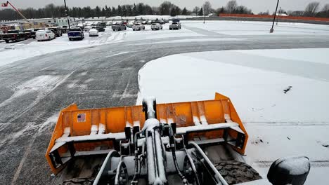 pov, bulldozer plowing snow to clear road after snow storm