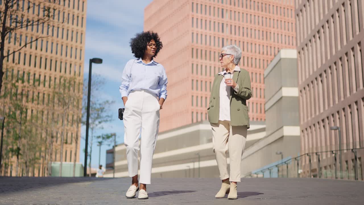 Two women walking in an urban environment