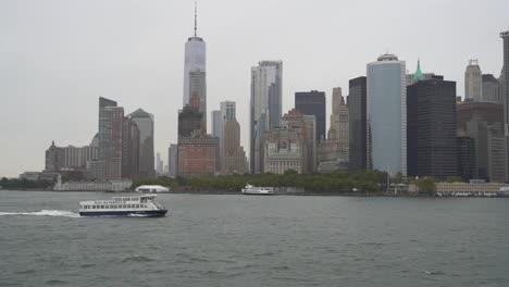 boat on hudson river with lower manhattan skyline new york city