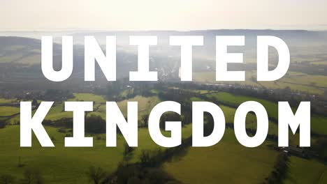 aerial drone shot of fields and countryside in uk with animated graphic spelling out united kingdom