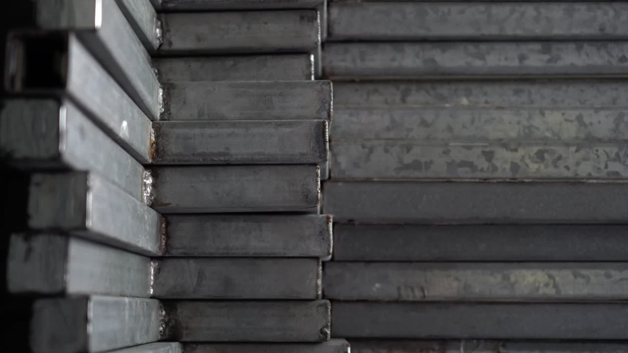 Metal recyclables are neatly arranged. Appearance is old. Tilt shot from top to bottom.