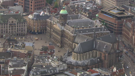 aerial zoom-out shot of the dam square in downtown amsterdam, netherlands