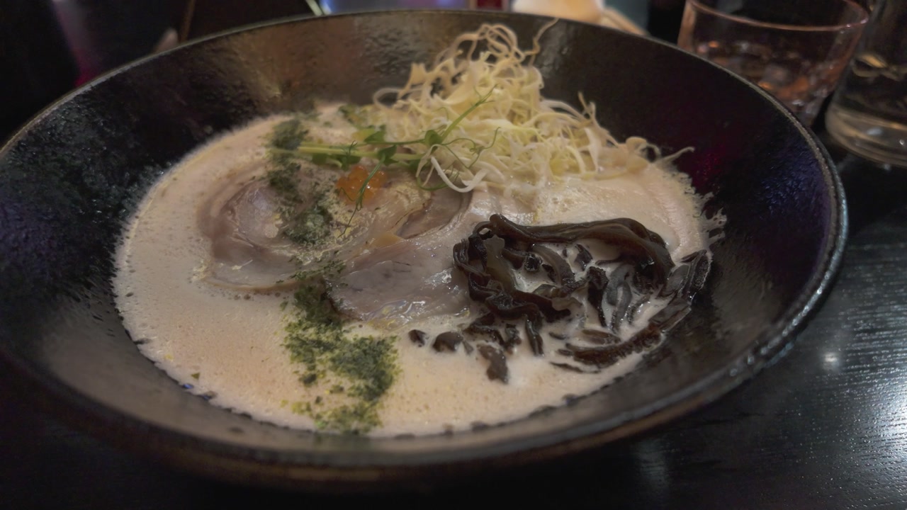 Closeup video of tonkotsu ramen at Tosakko Ramen in Paris, featuring creamy broth and chashu pork
