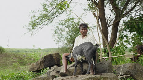 man and goat in rural setting