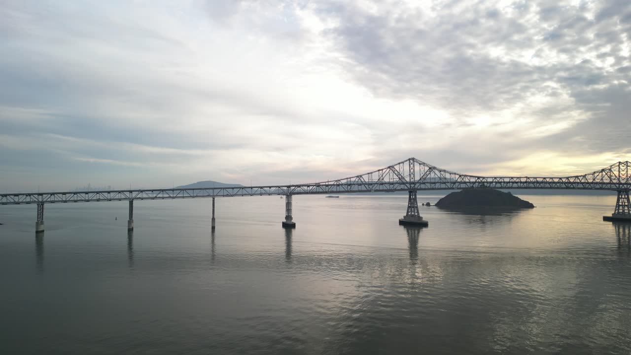 A drone soars near the Richmond–San Rafael Bridge, revealing its structure and Point Molate Beach.