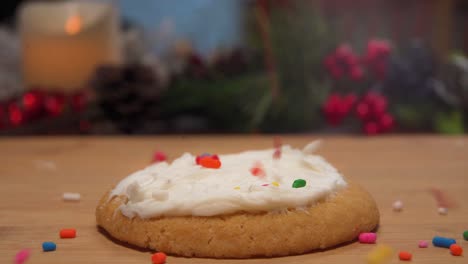 A-close-up-slow-motion-clip-of-sprinkles-falling-onto-a-holiday-cookie