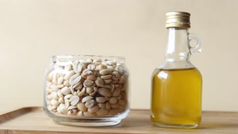 peanuts and oils in a container on table ,