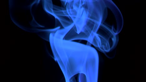 thin trickle neon-blue smoke slowly rising graceful twists upward. colored smoke blowing from bottom to top. close-up, isolated on black background