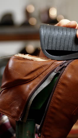 shoemaker repairing a shoe