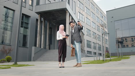 business colleagues taking selfie outdoors