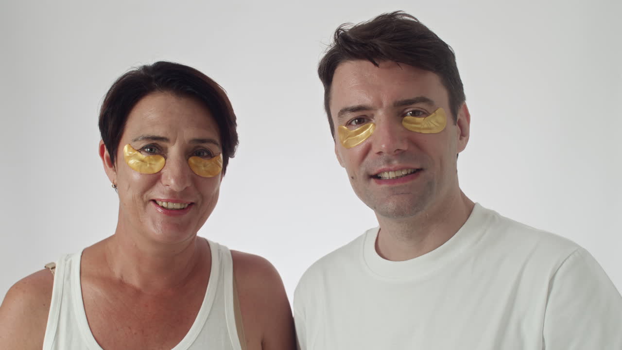 Smiling Middle-aged Couple with Applied under Eyes Patches
