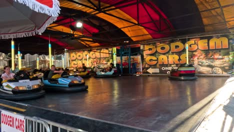 people enjoying bumper cars at a fun fair