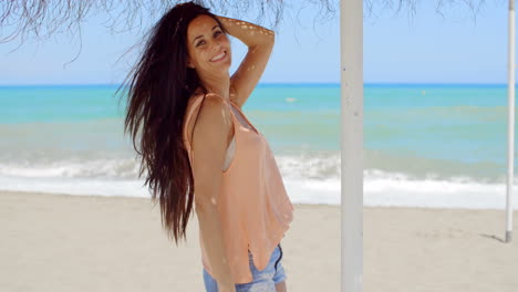 Happy-Pretty-Young-Woman-Under-a-Beach-Umbrella