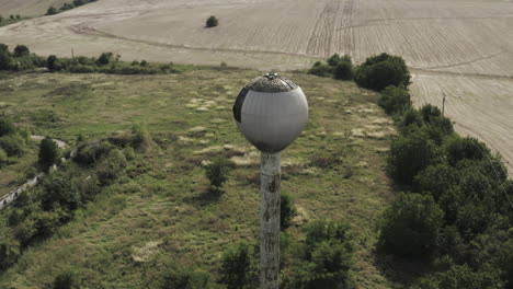 Rotating-Aerial-view-of-old-abandoned-water-reservoir-tower