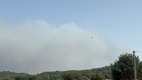 helicopter with a water bucket to extinguish a fire in northern spain
