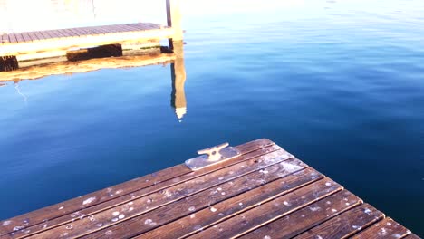 sunrise at the dock as the water slowly ripples by the bay