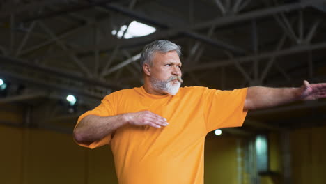 senior man stretching indoors