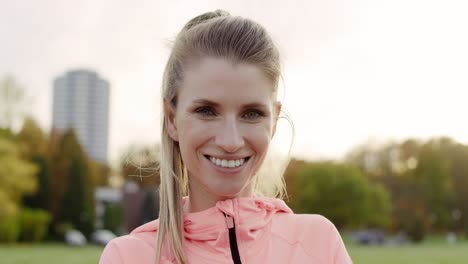 handheld video shows of sporty smiling woman after jogging training