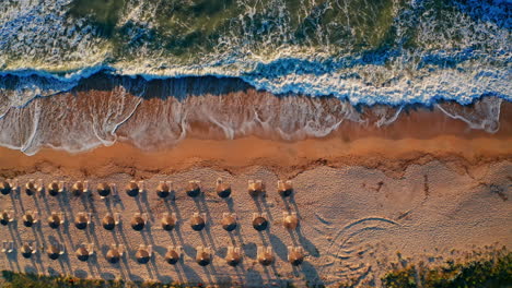 Top-down-aerial-drone-shot-of-a-tropical-beach-at-sunset