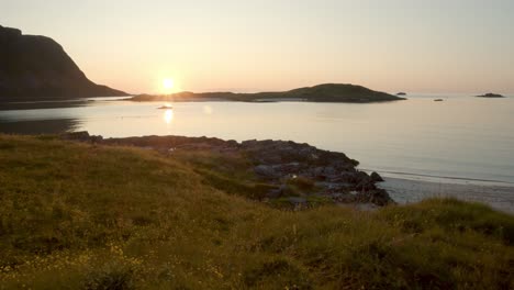 smooth tracking shot of the sunset on the beach of the lofoten in norway