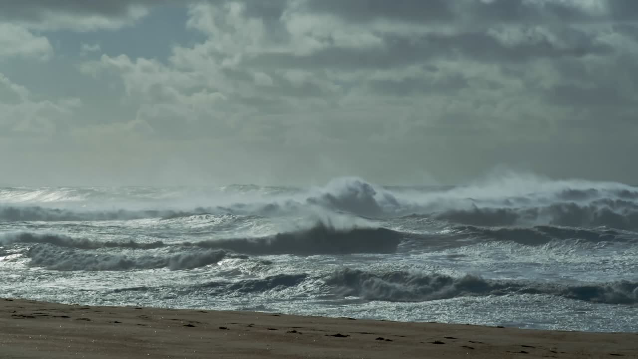 Powerful ocean surf breaks in slow motion along scenic Atlantic coast