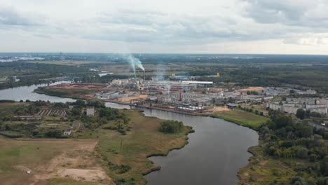 Aerial-panoramic-drone-video-of-a-factory-on-the-riverside-on-a-cloudy-day
