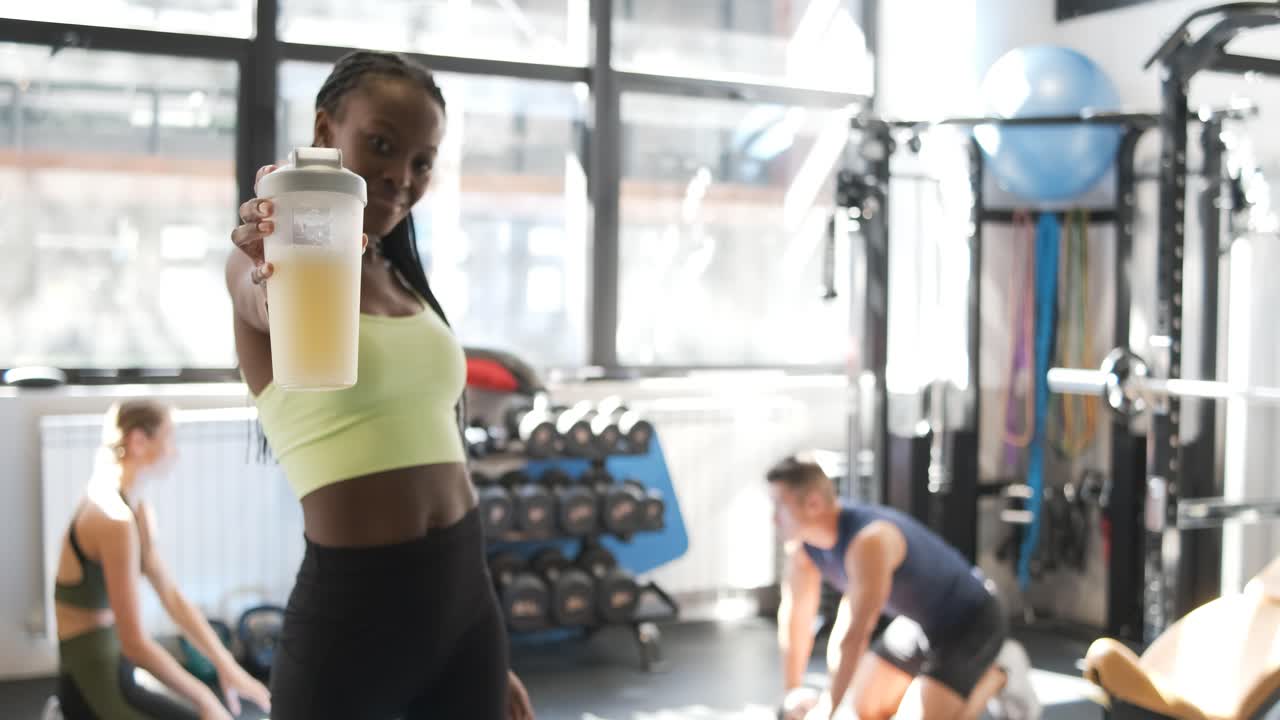 Woman Drinking Protein Shake in Gym