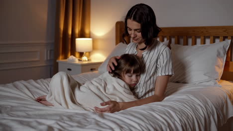 mother and daughter sleeping peacefully in bed