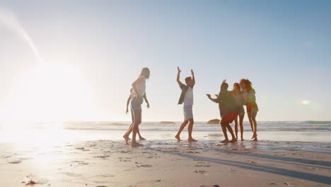 Group-Of-Friends-On-Shoreline-Having-Fun-On-Beach-Vacation