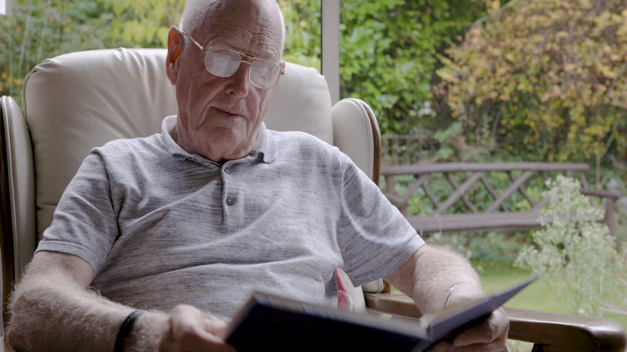 Elderly man sitting in a chair indoors