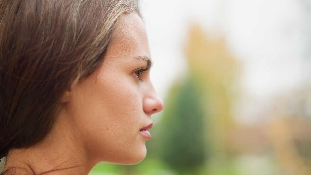 Portrait view of lady's face with visible goosebumps all over, emotional reaction to cold or excitement, natural skin, close-up expression, soft lighting, calm and serene outdoor shot