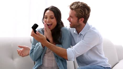 Man-surprising-his-partner-with-engagement-ring