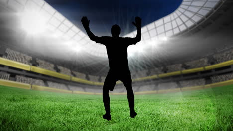 animation of silhouettes of football player kicking ball over sports stadium