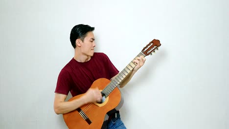 asian guy rock style with his acoustic guitar