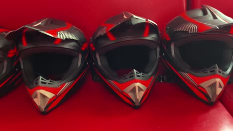 three black and red motorcycle helmets