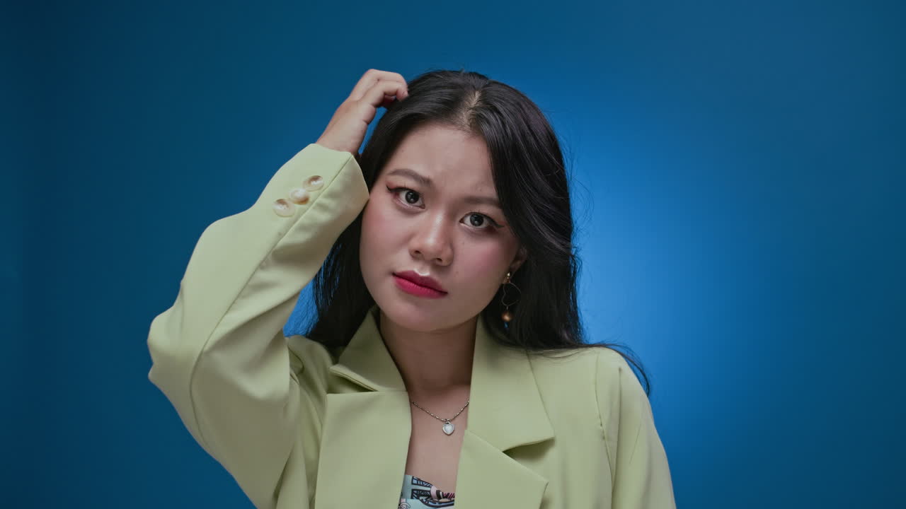 Asian Woman Being Surprised Isolated on Neon Blue Wall Background