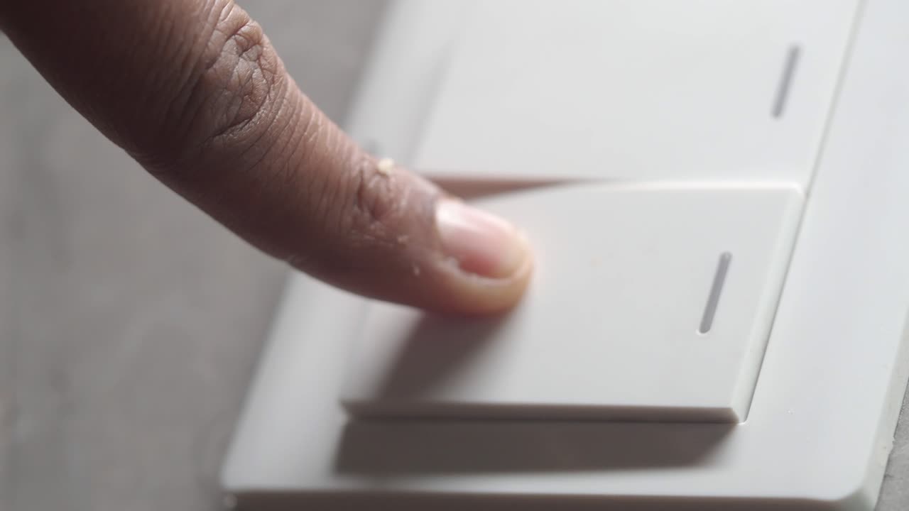 Finger pressing a white light switch