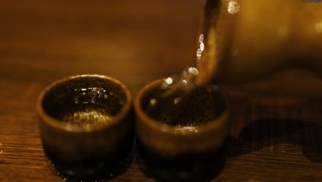 sake being poured into two cups