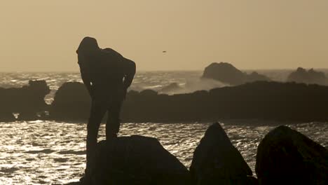 a man jumping from a valley to the beach