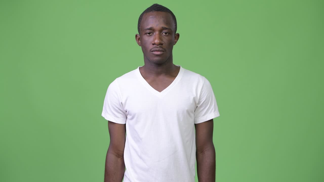 Young African man pointing at camera