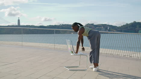 Sensual-guy-burlesque-chair-dance-perform-sea-view.-Contemporary-dancer-training